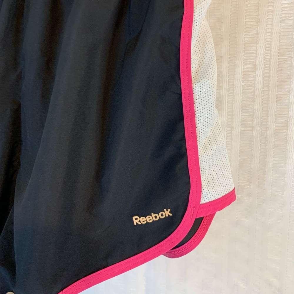 Reebok running shorts in black, pink and a little white trim. Size medium.